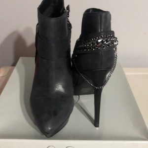 Dark blue distressed leather high heeled booties.